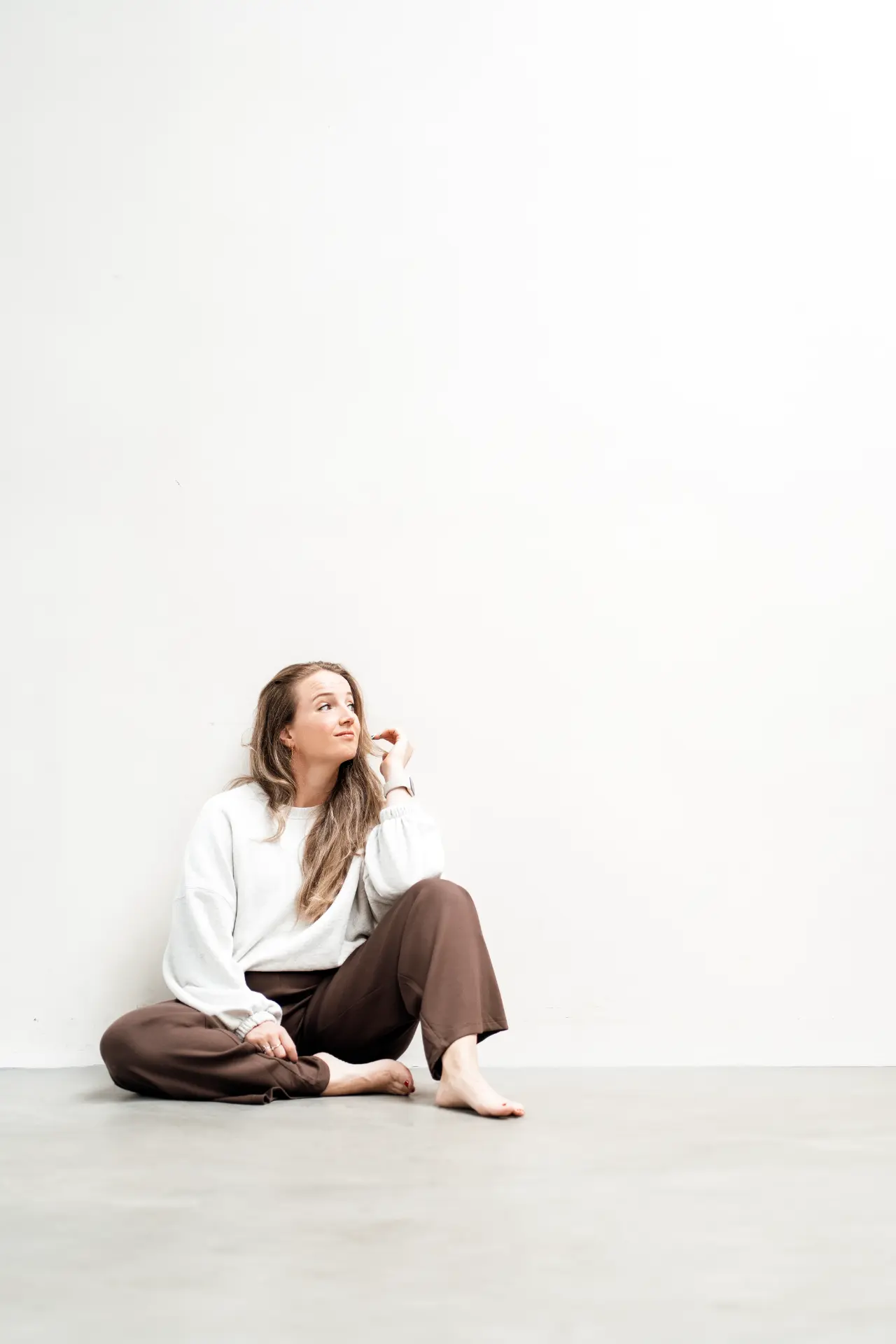 Marina seated in a bright open studio
