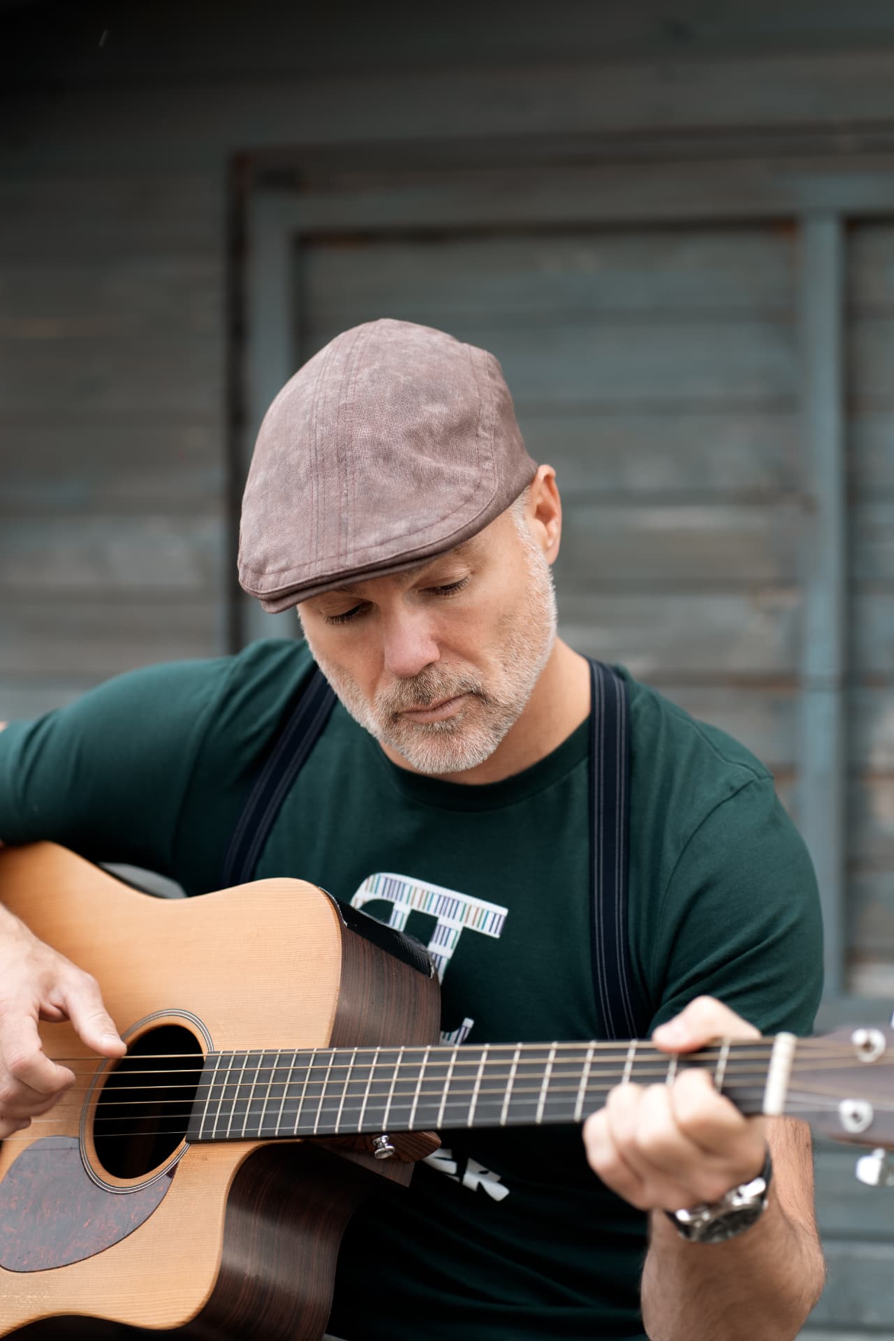 Close portrait of Peter playing guitar