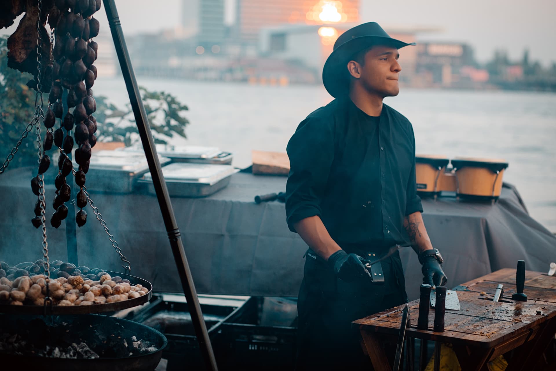Chef tending the open fire beside the Amsterdam waterfront
