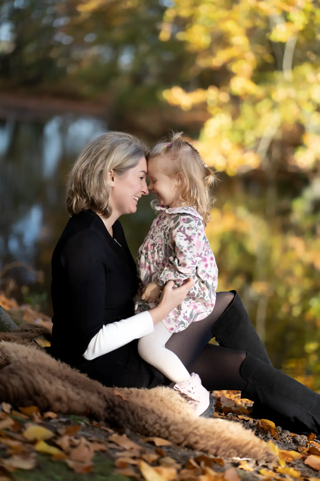 Mother and daughter sharing a joyful moment by the water