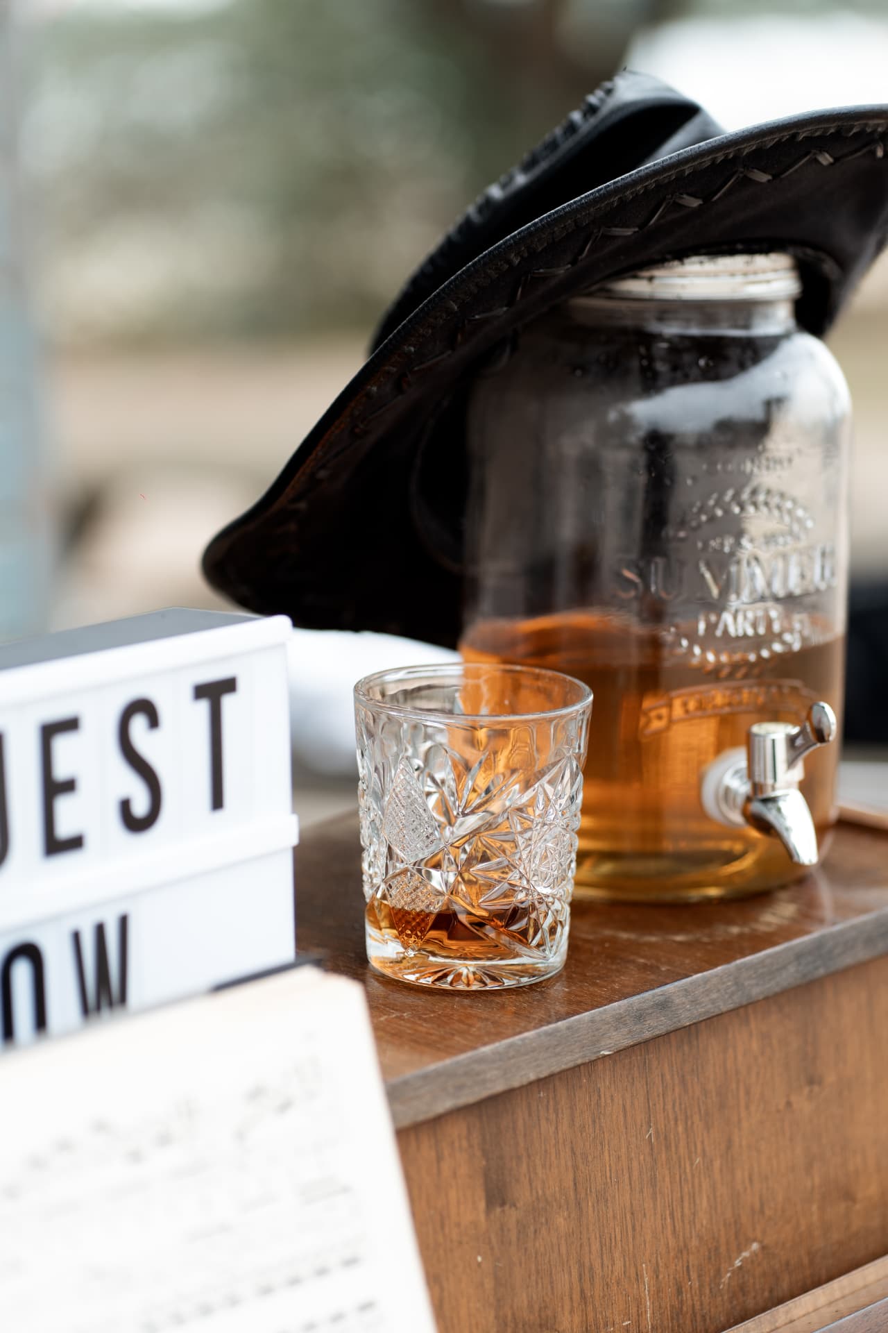 Whiskey glass and hat resting on the piano