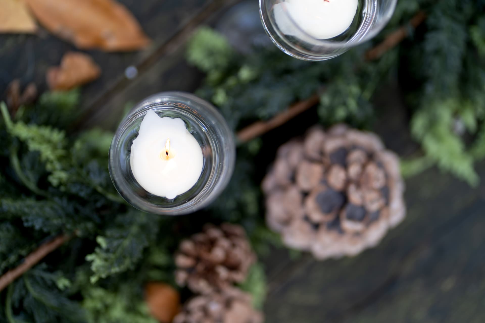 Candles and pinecones on the autumn tea table