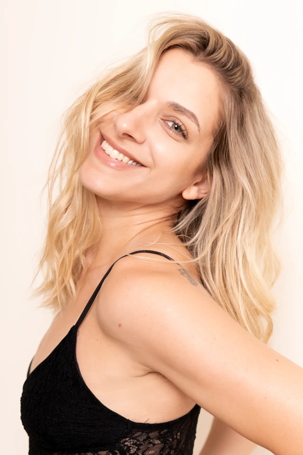 Close portrait of Lia smiling over her shoulder
