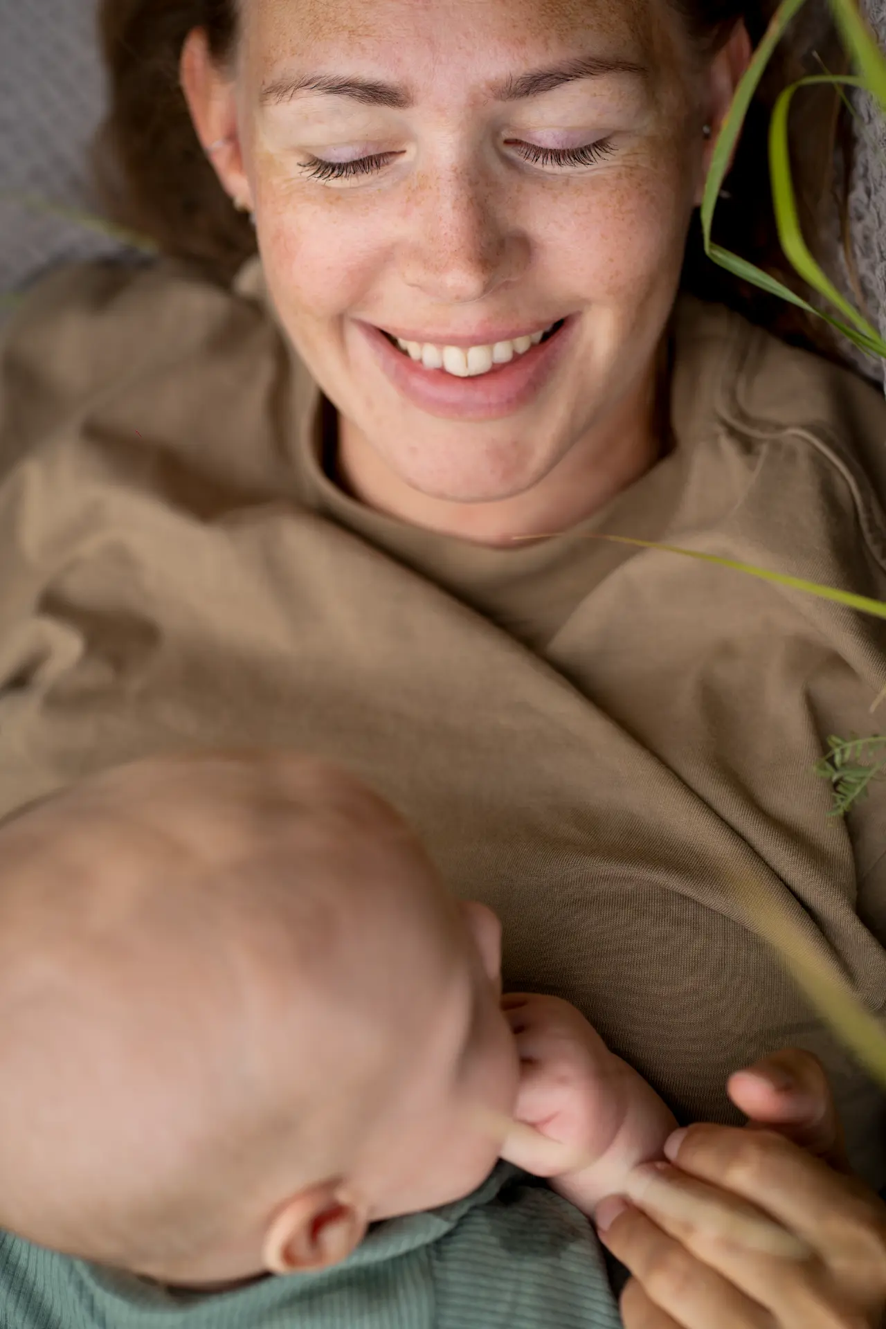 Mother smiling down at her baby, seen from above