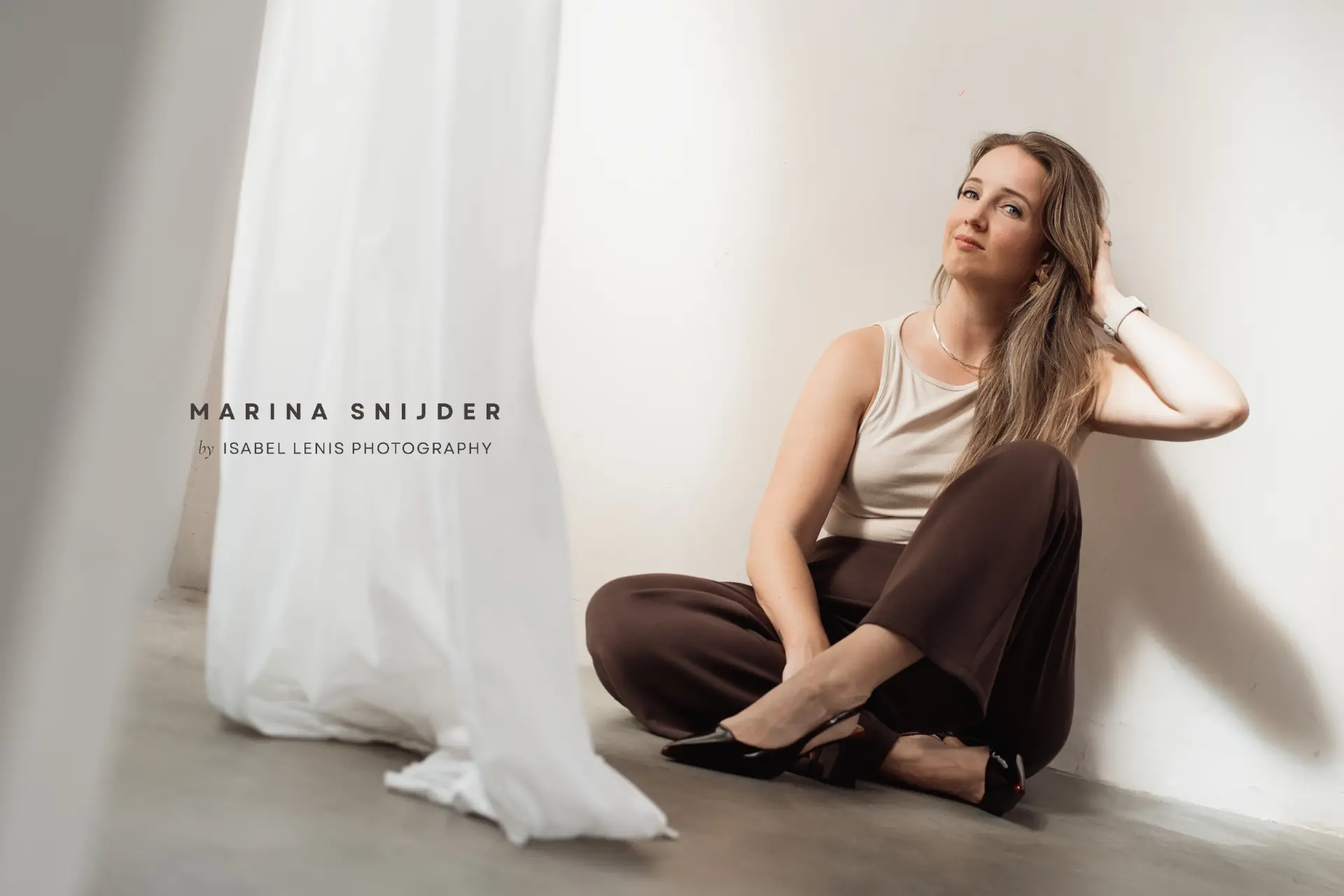 Marina Snijder seated in a sunlit studio with title typography