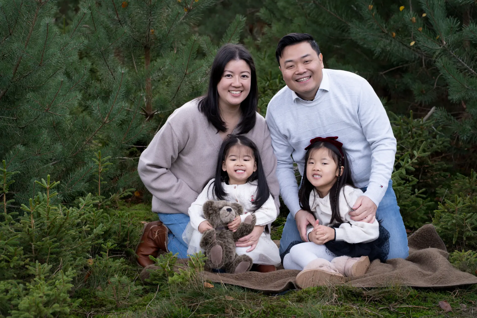 Family walking among the Christmas trees