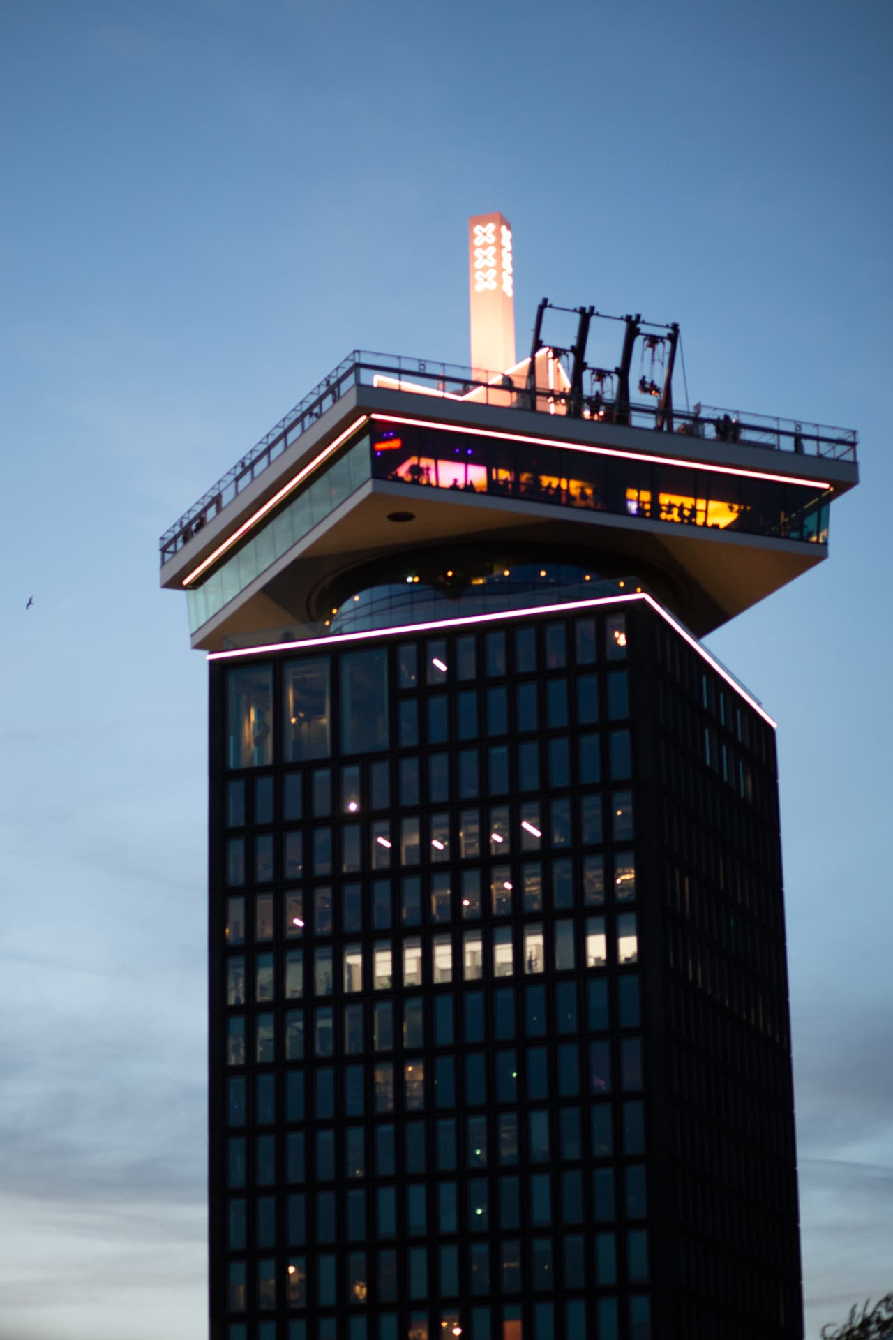 A'DAM Tower illuminated against the blue evening sky