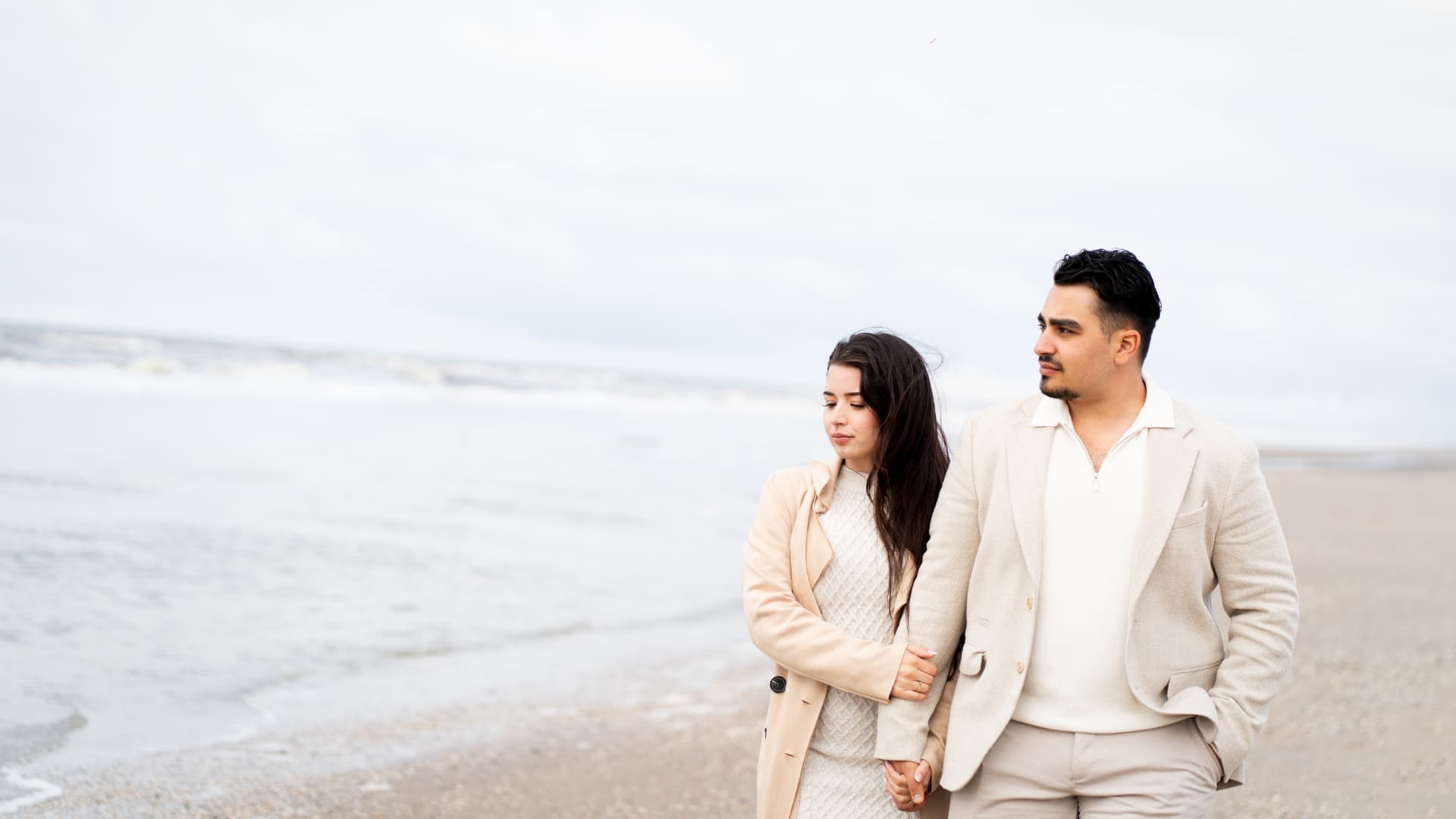 N and Y walking together along the shoreline