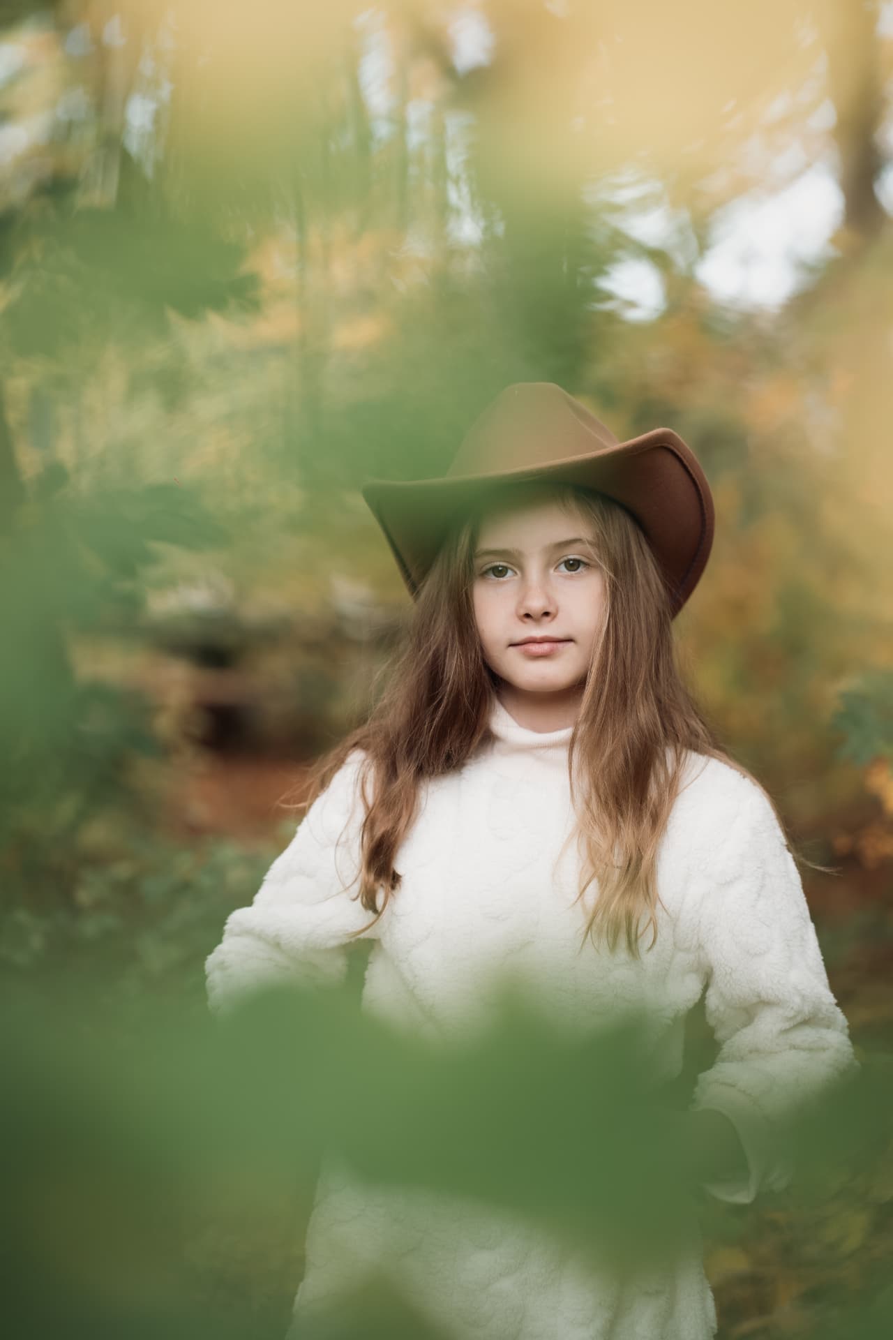 Autumn portrait of a girl in a brown hat