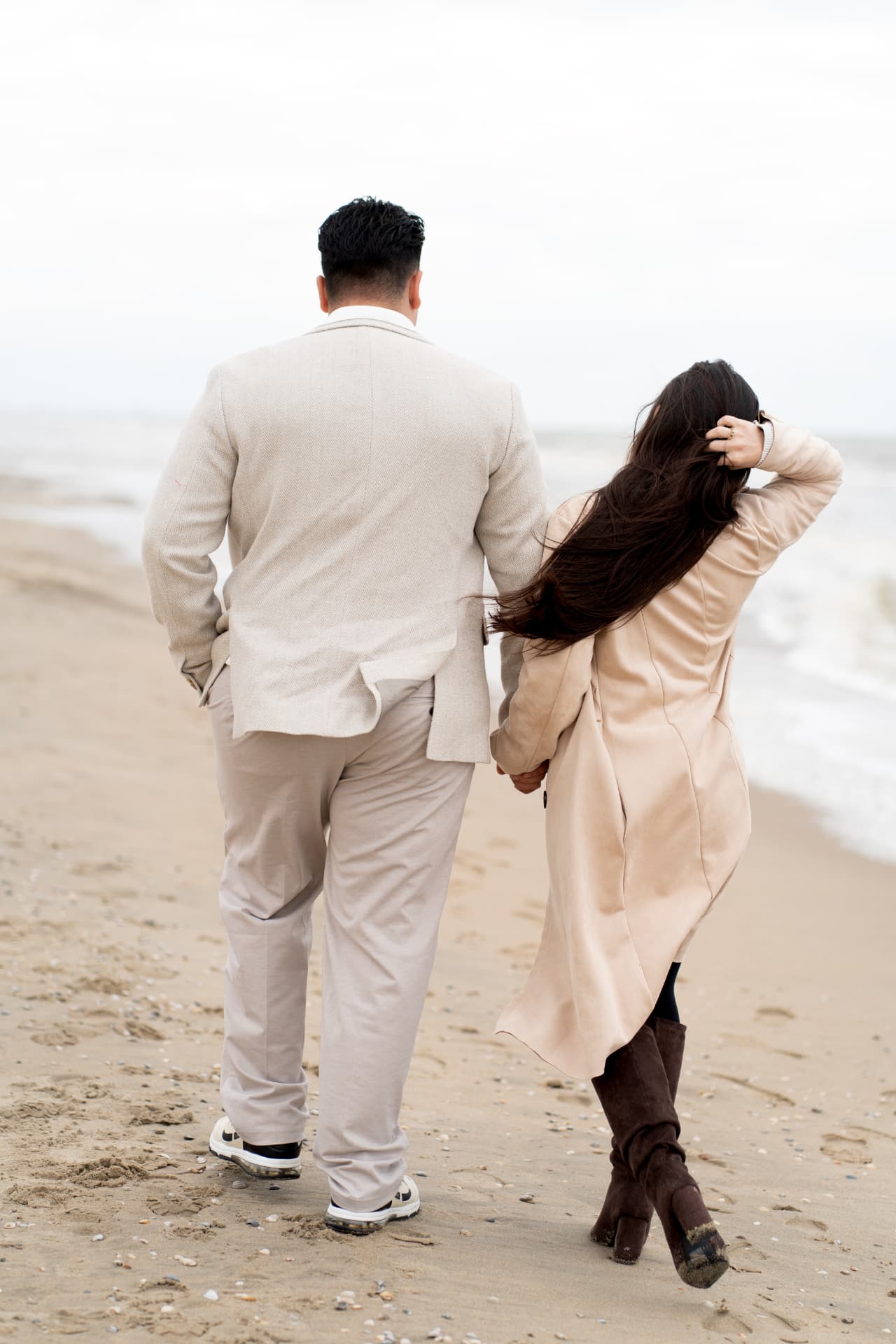 N and Y walking together along the shoreline