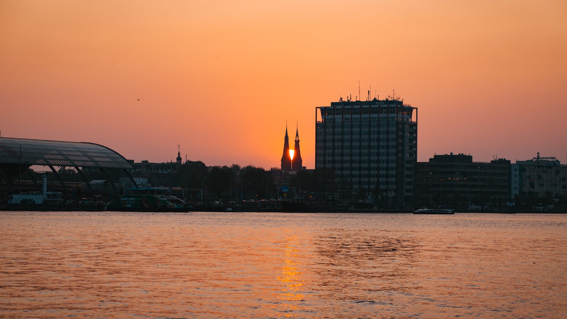 Amsterdam sunset reflected across the water at Tardes Colombianas