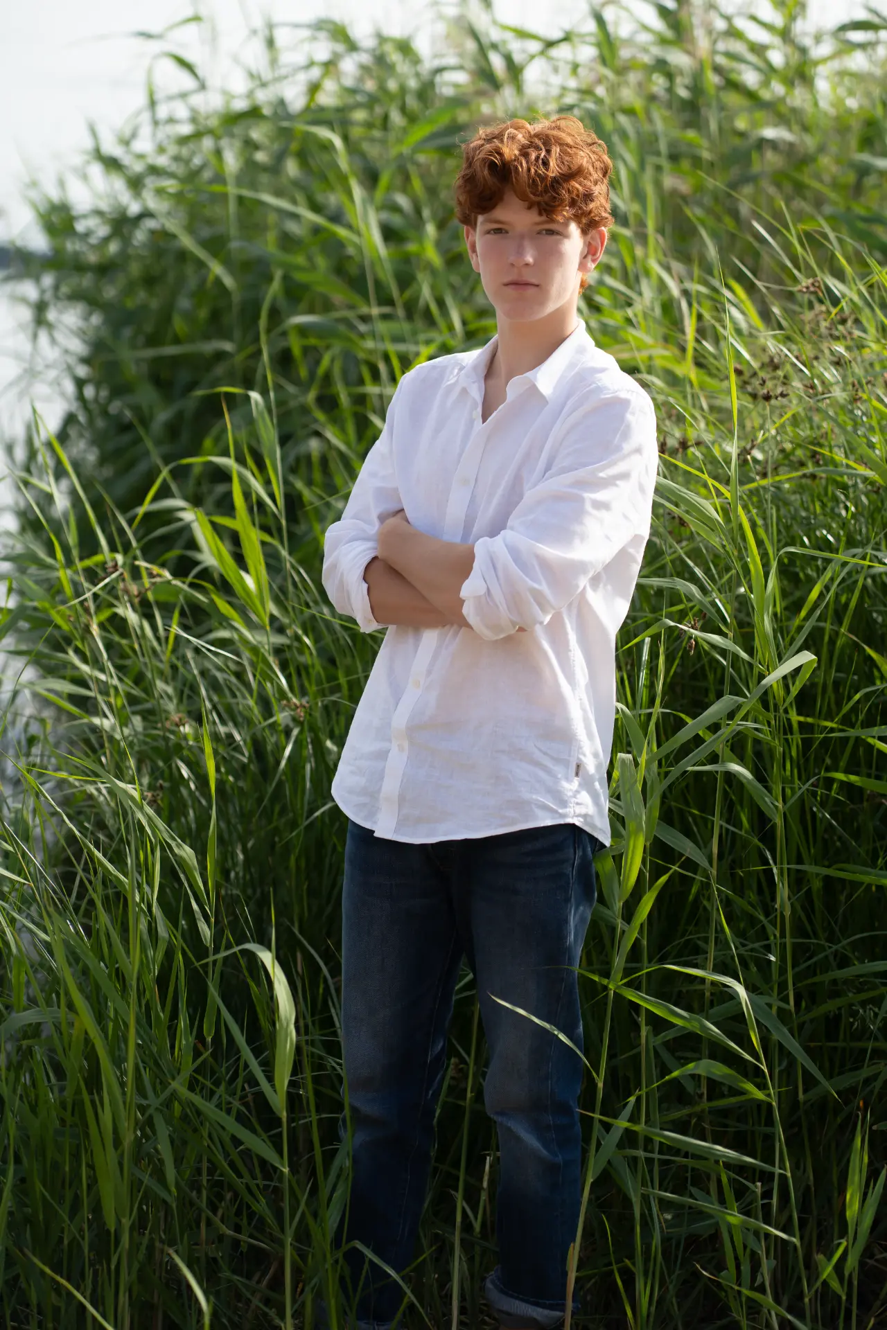 Shey standing among tall green reeds