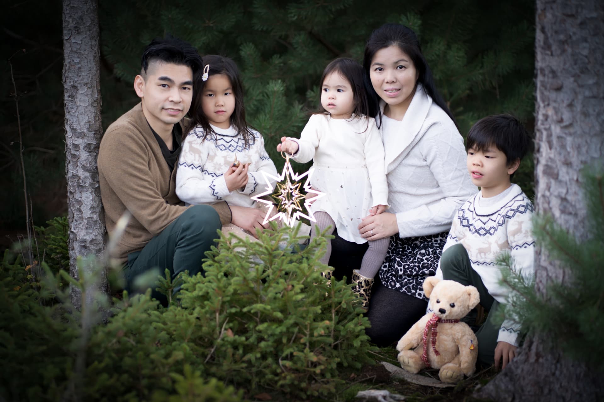 Family gathered among the Christmas trees