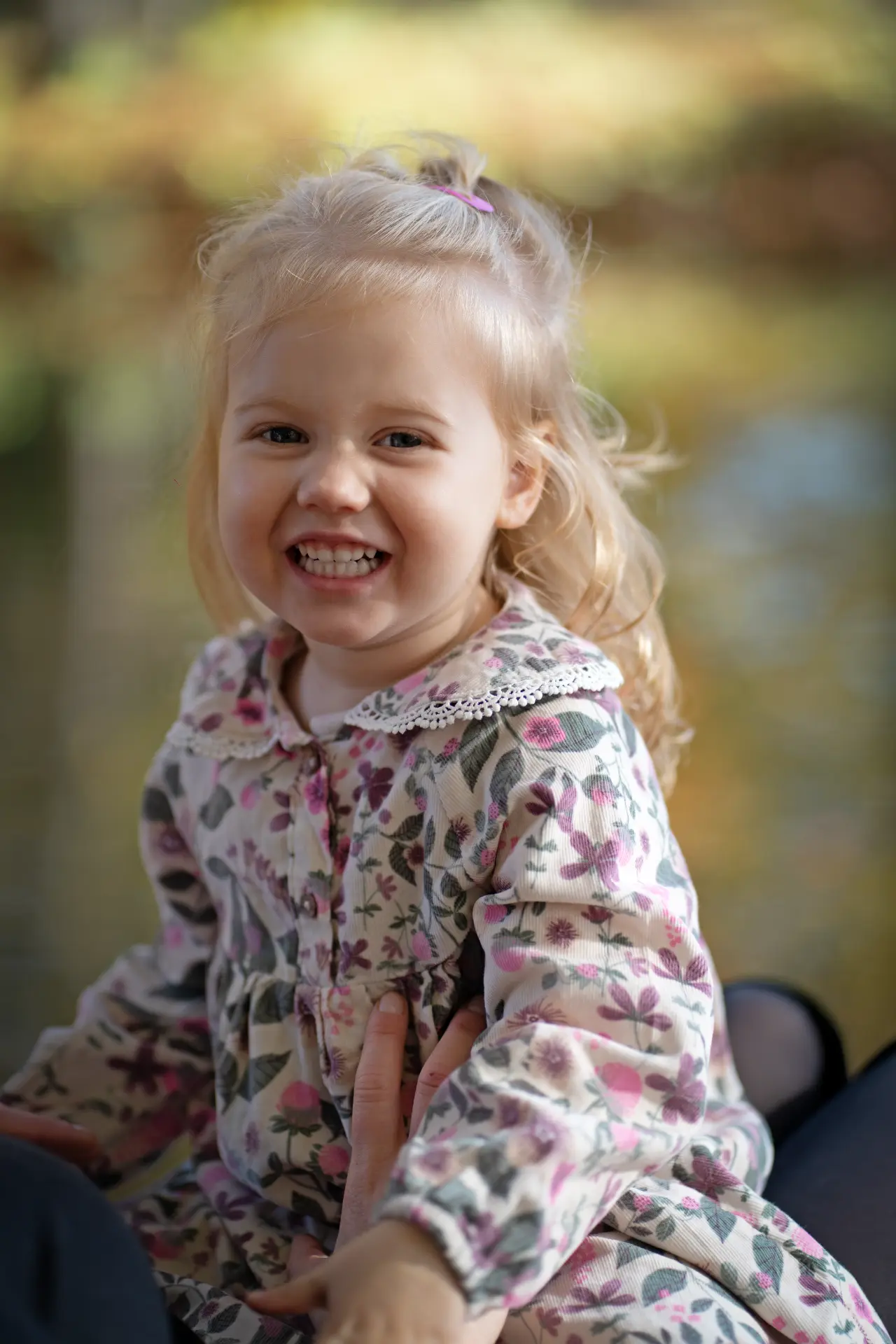 Smiling portrait of a young girl in a floral dress