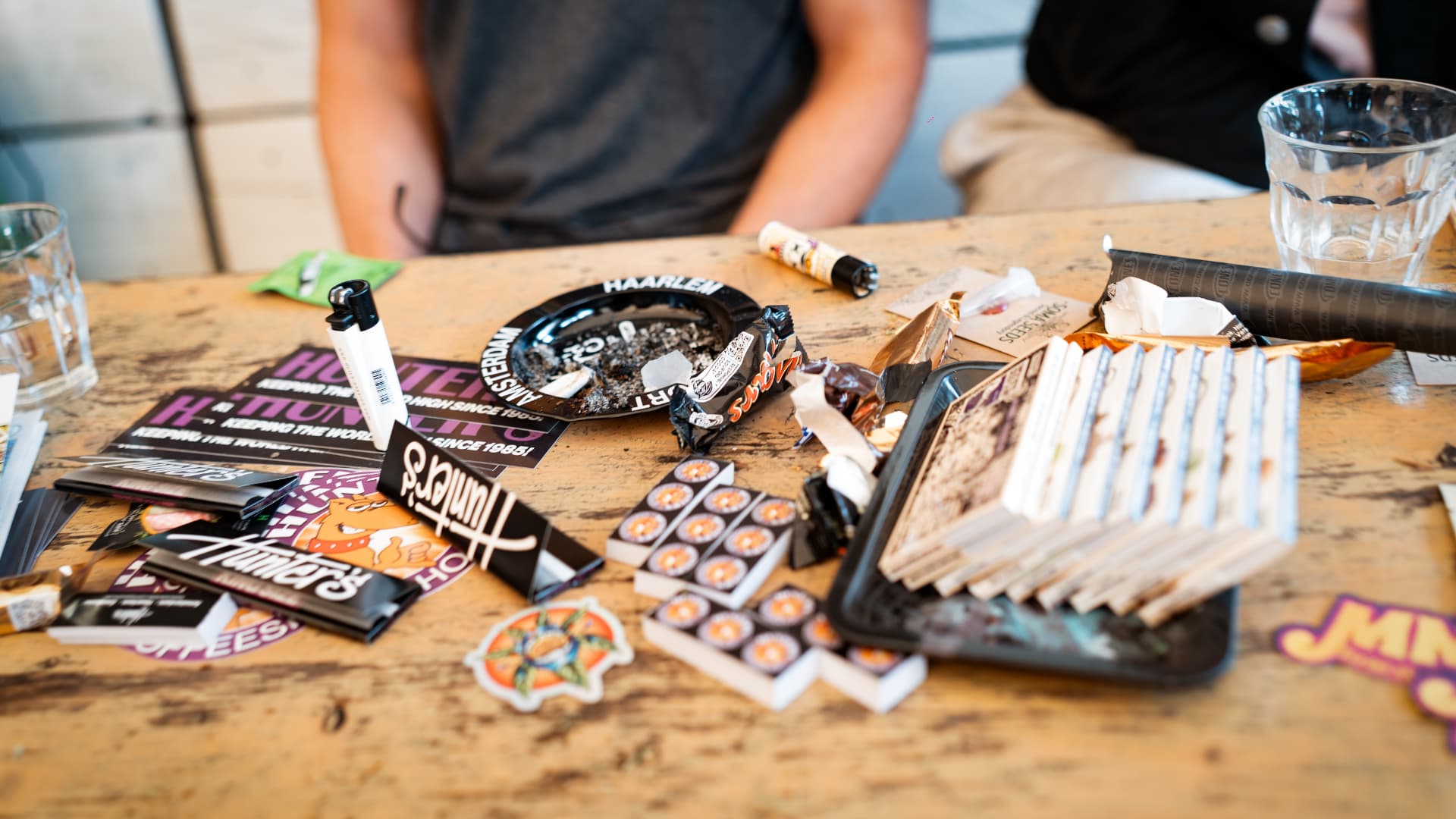 Table detail with papers, stickers and glasses