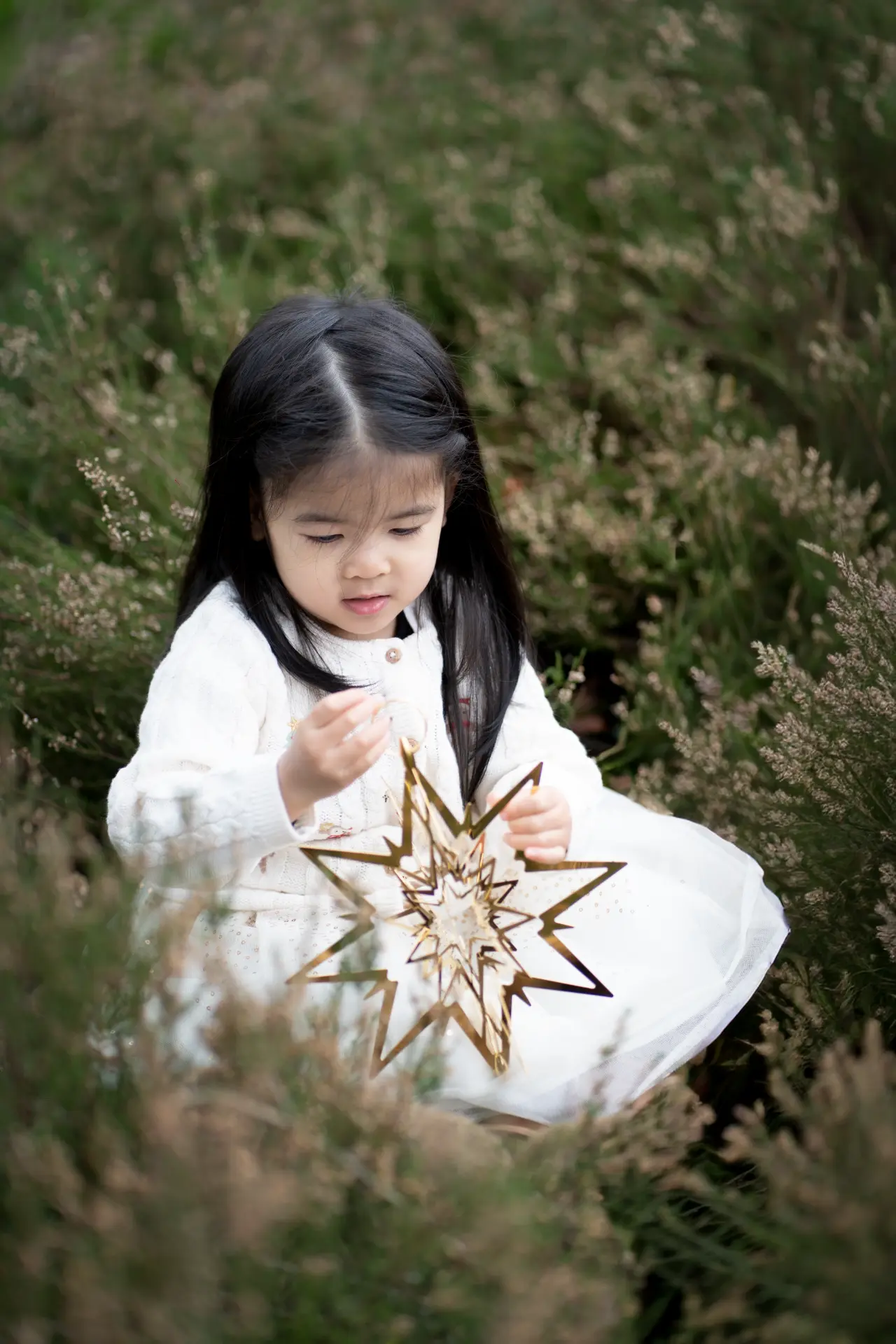 Girl in a red bow among the Christmas trees