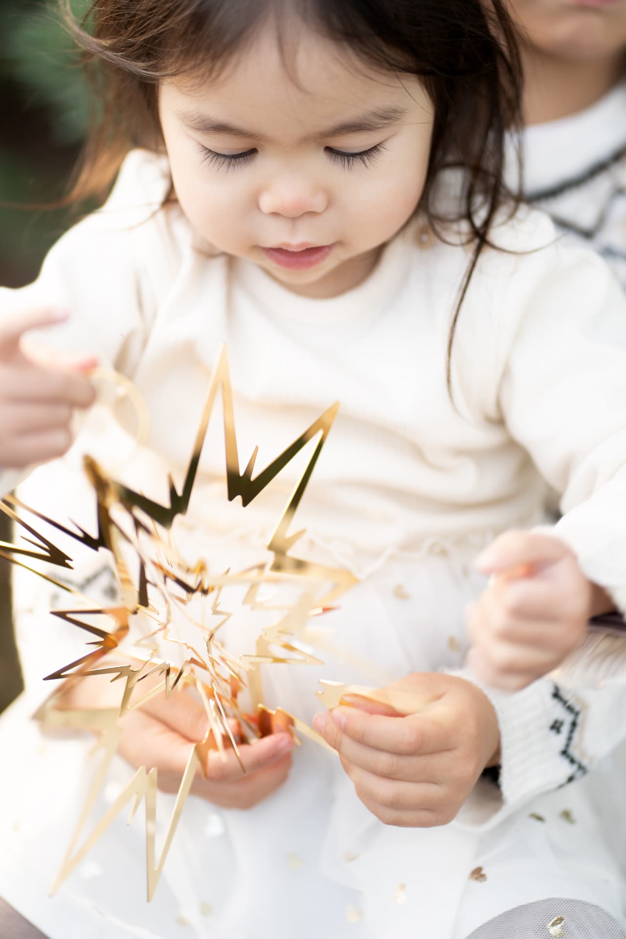 Little girl discovering a golden Christmas star
