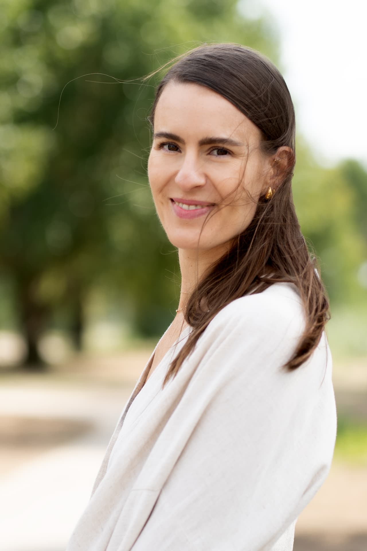 Portrait of a mother in linen looking over her shoulder