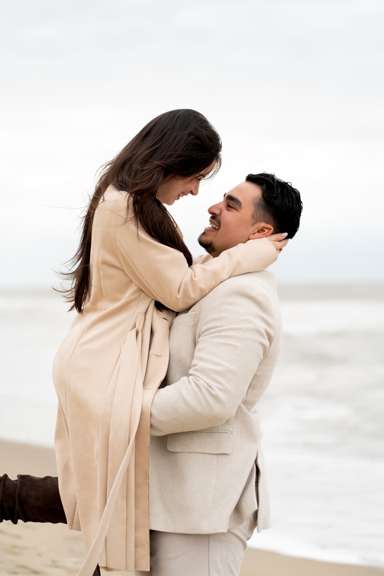N and Y embracing on the beach