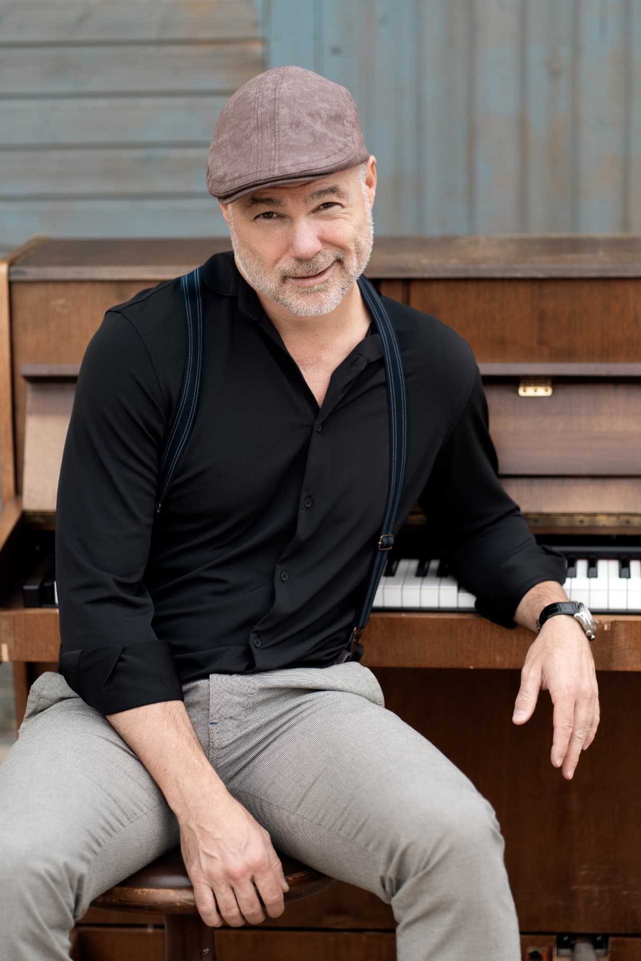 Peter seated at his piano in a black shirt