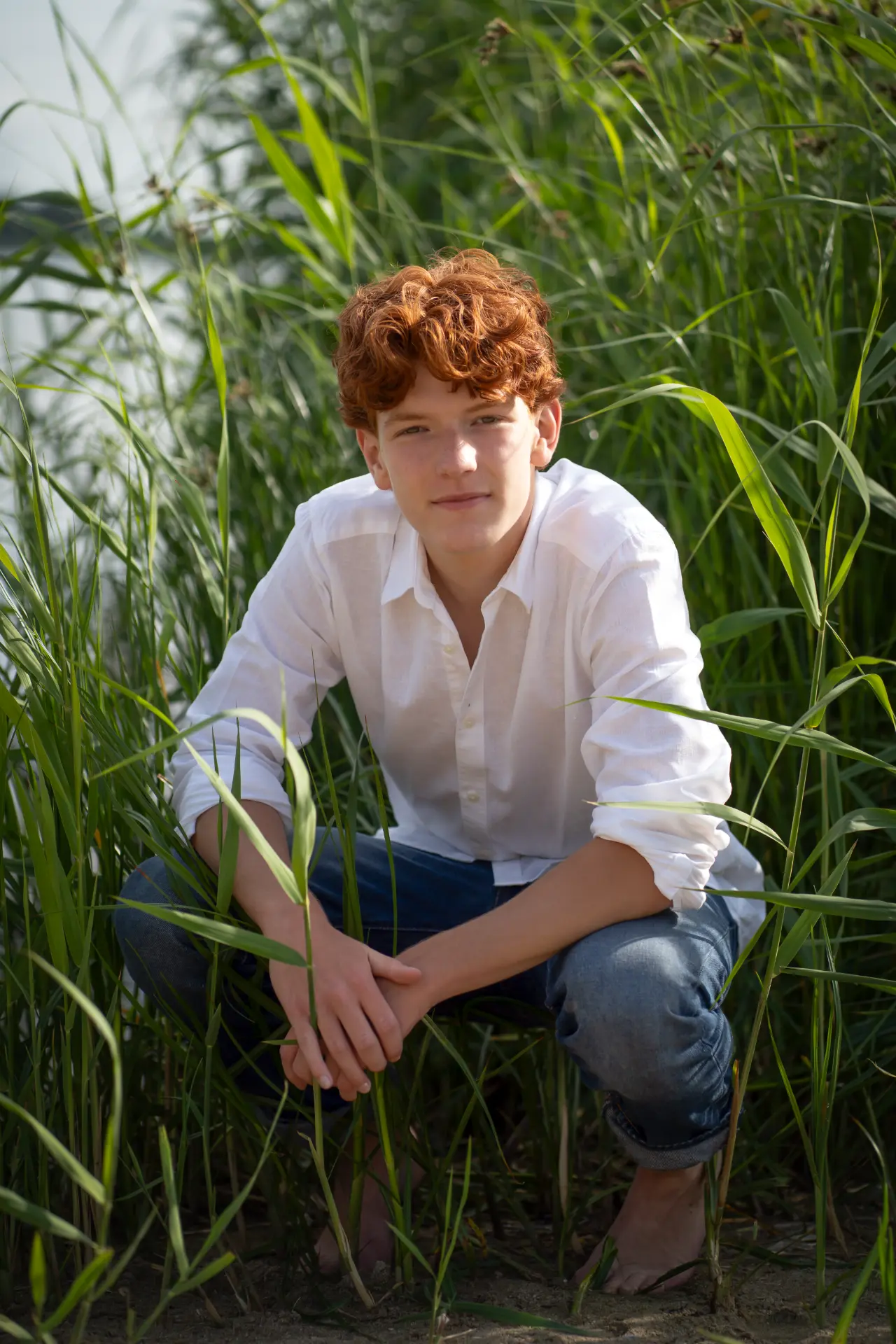 Shey seated among tall green reeds