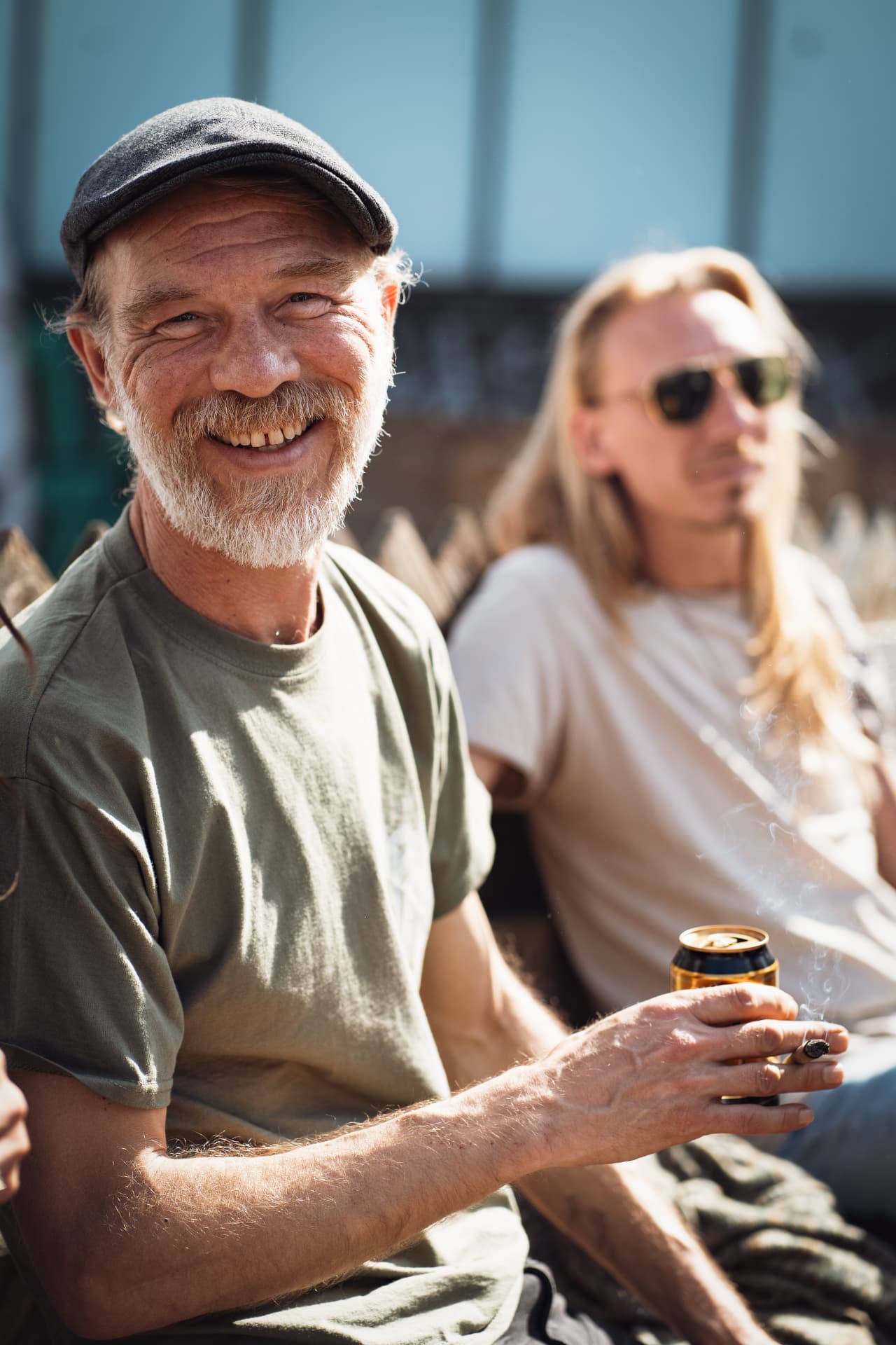 Laughing guest in a flat cap in the afternoon sun