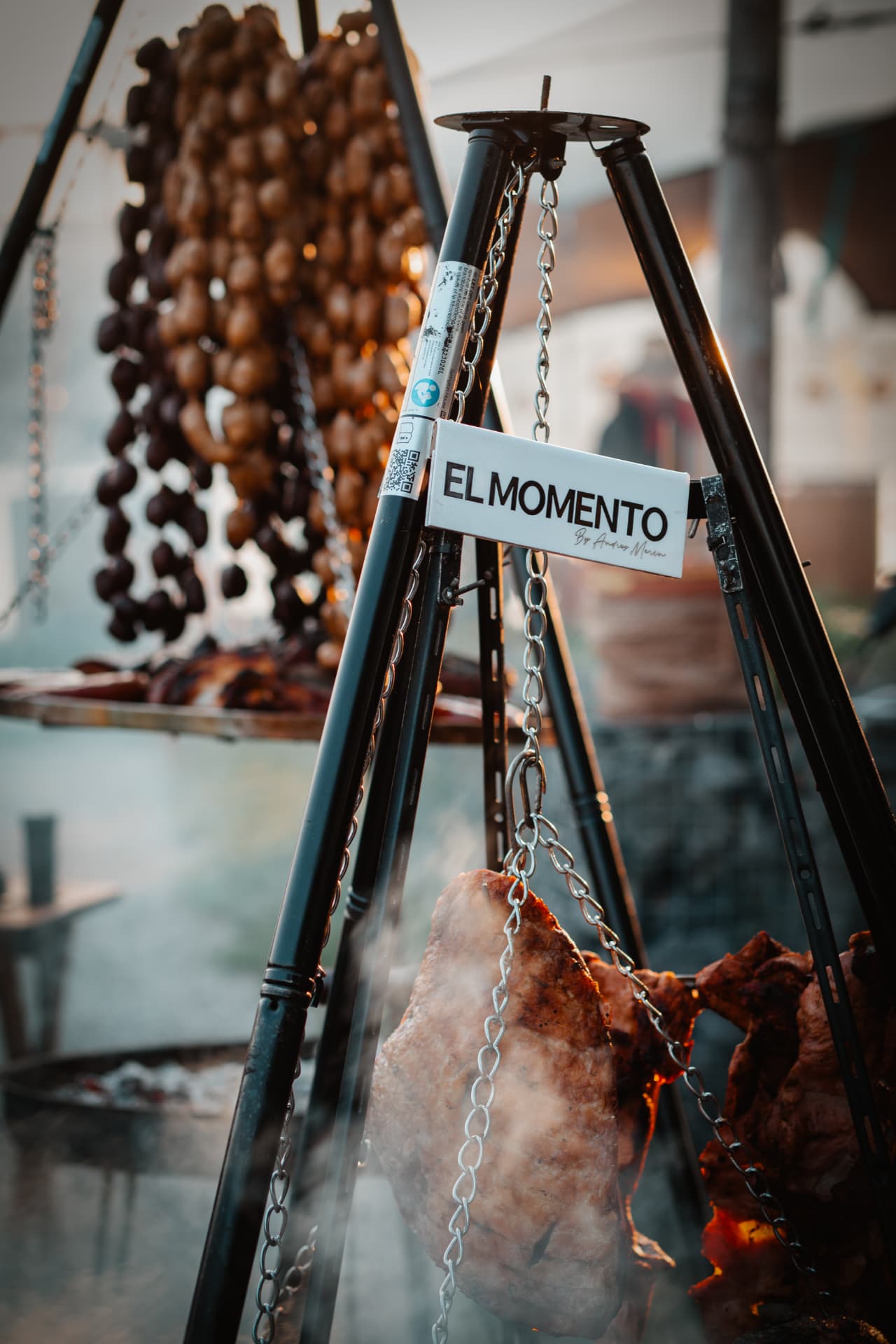 El Momento grill smoking beneath hanging decorations