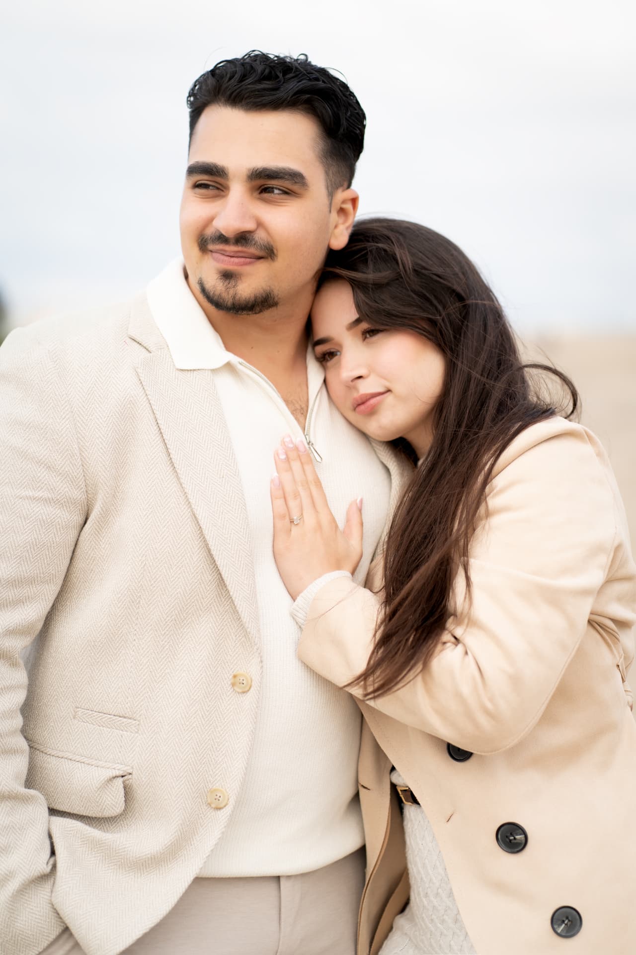 N and Y in a quiet embrace by the sea