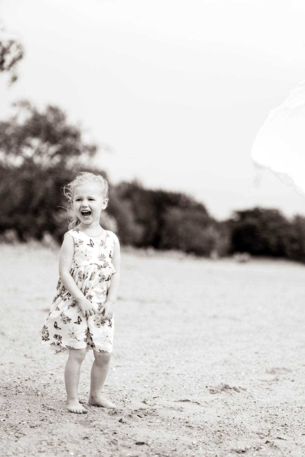 Girl laughing out loud on the open sand