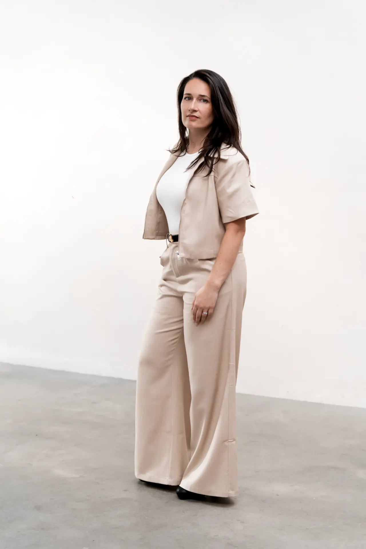 Full-length portrait of Suzana in a light neutral suit
